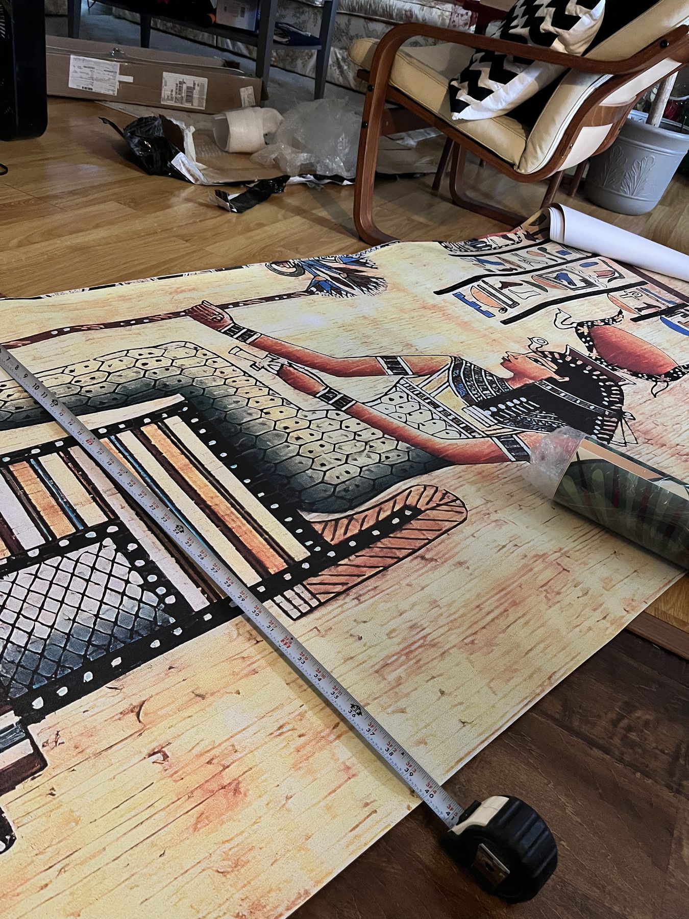 Illustrated mural wallpaper panels laid out on the floor before installation