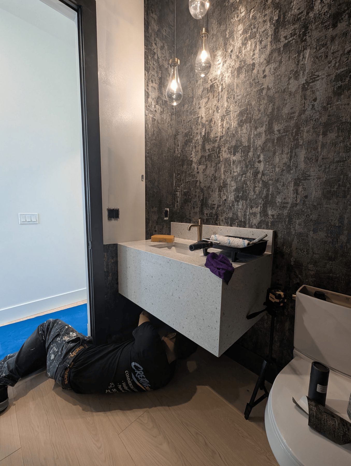 Wallpaper installation near a bathroom vanity