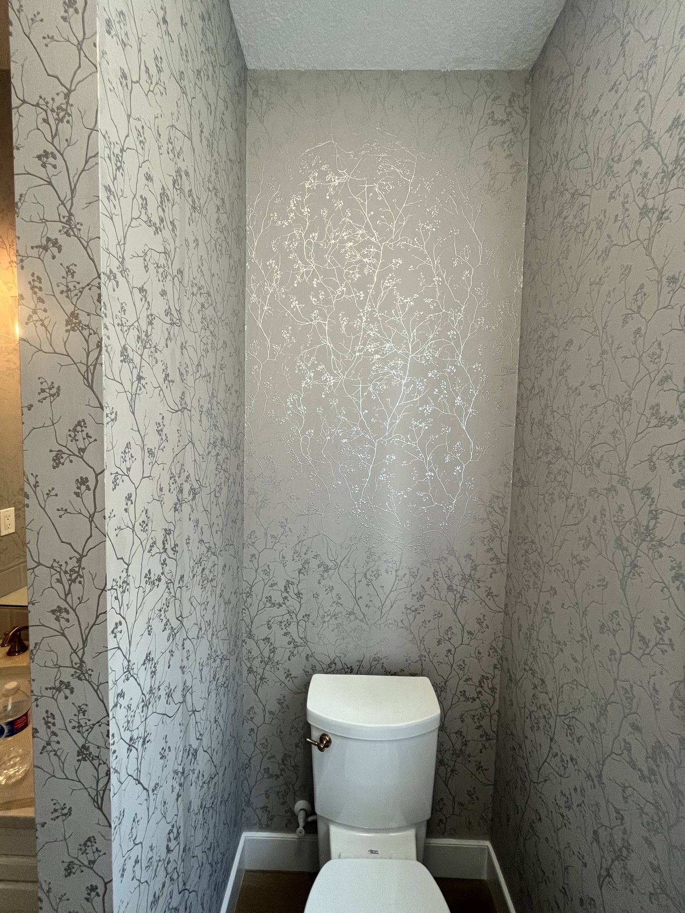 Powder room with metallic floral wallpaper