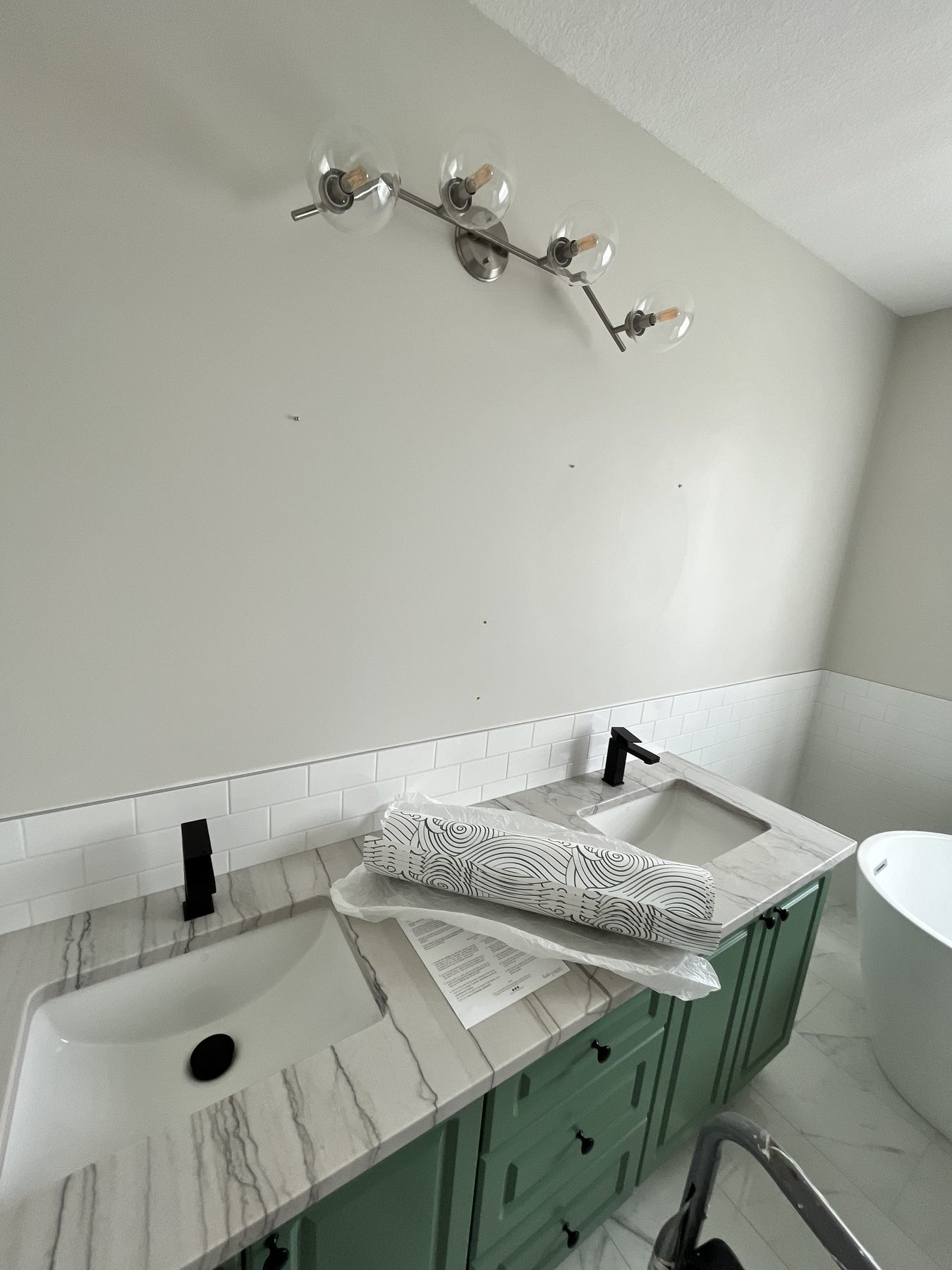 Bathroom vanity with wallpaper rolls ready for installation