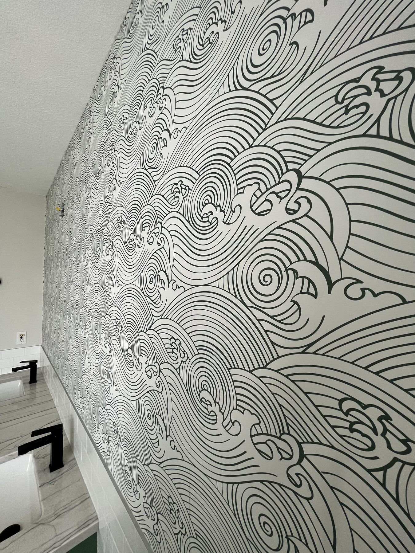 Black and white wave pattern wallpaper in a bathroom