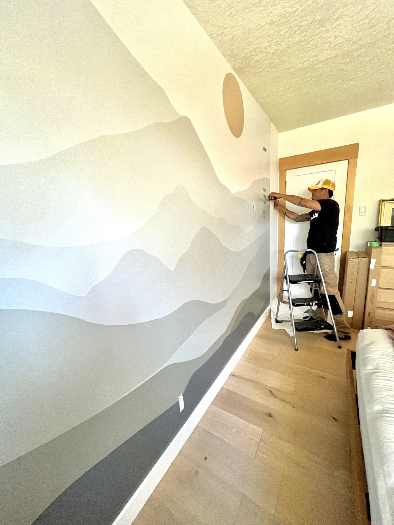 Soft mountain landscape mural wallpaper in a bedroom