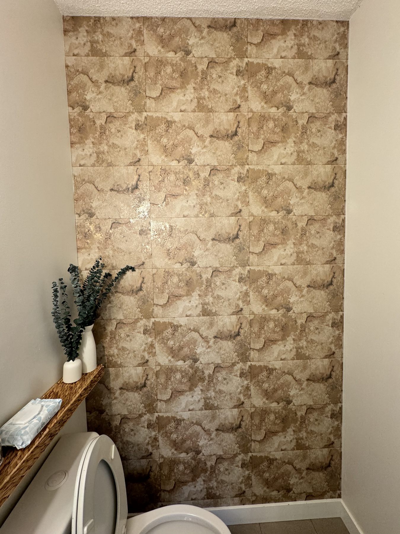 Bathroom accent wall finished with stone-look wallpaper